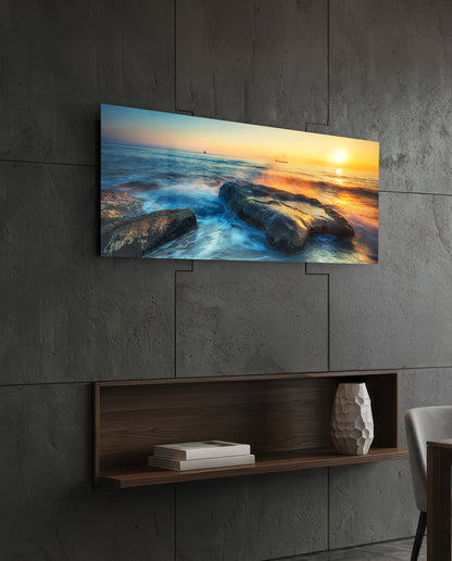 Mossy rocks sunrise sea glass wall art above a dark wood wall shelf on a charcoal paneled wall