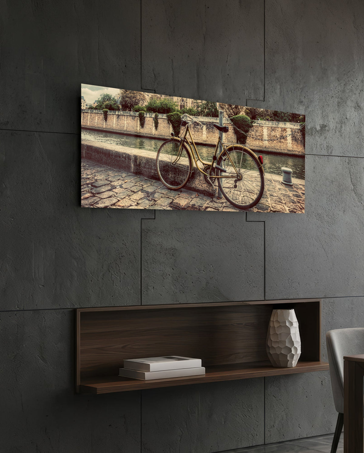 Vintage riverside bicycle glass wall art on a dark tiled wall above a recessed walnut shelf with a vase