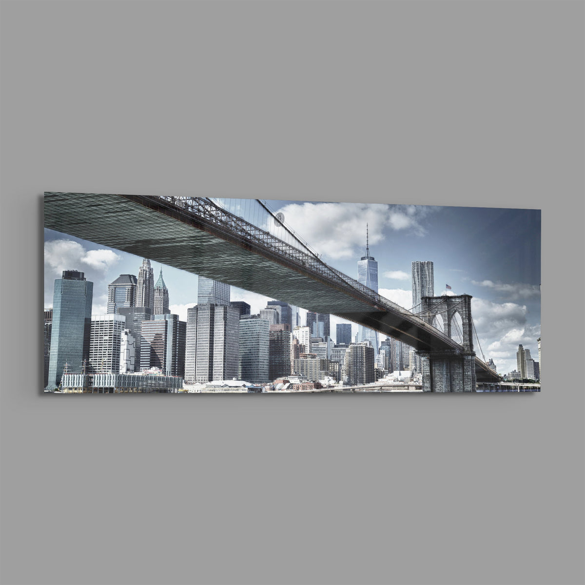 Brooklyn Bridge skyline panoramic glass wall art shown at an angle on a gray background