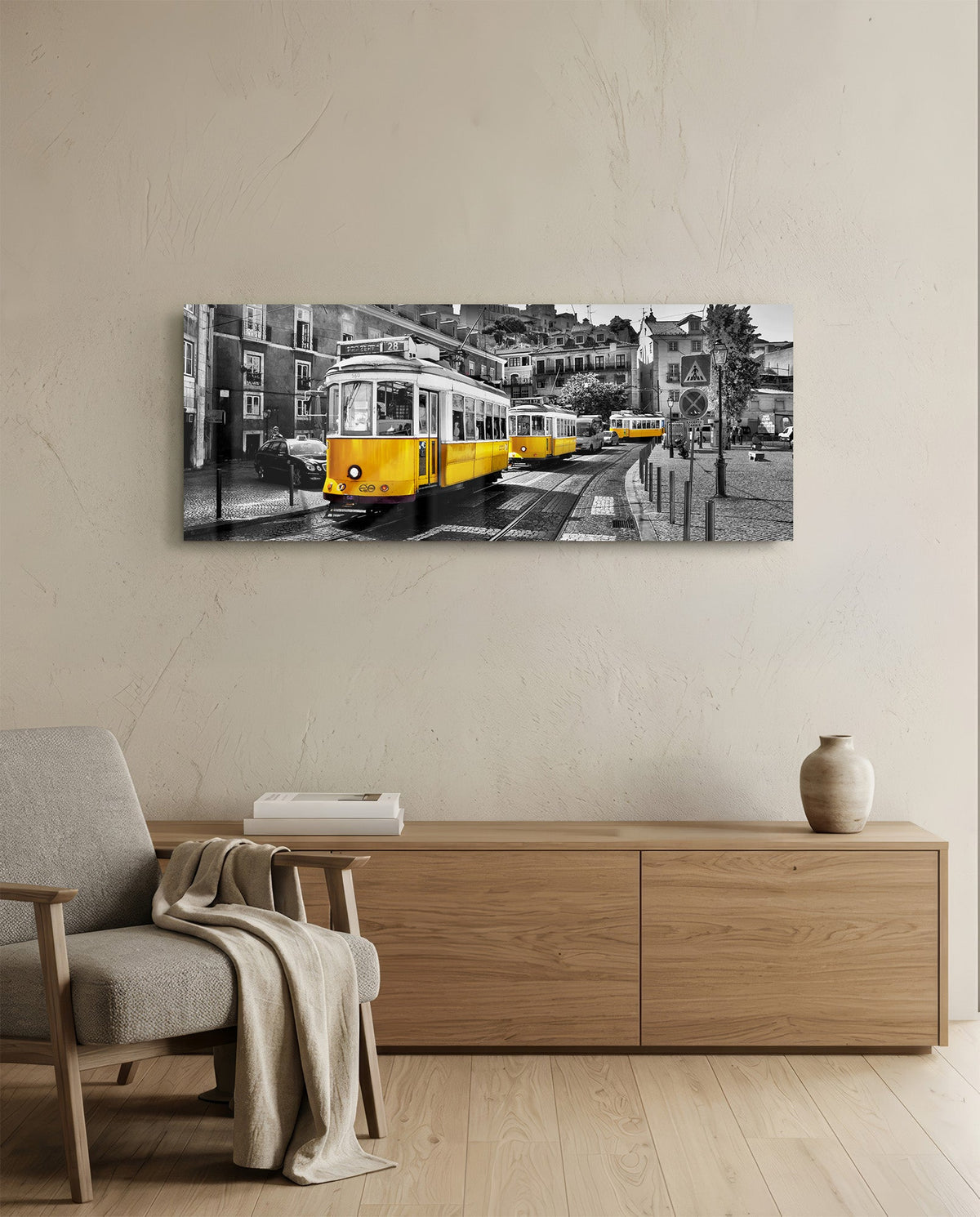 Lisbon tram panoramic glass wall art above a wooden sideboard and a cream armchair