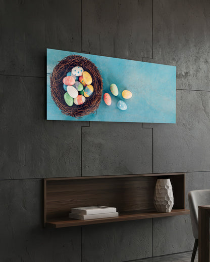 Easter eggs in a nest glass wall art on a dark tiled wall above a recessed walnut shelf with a vase