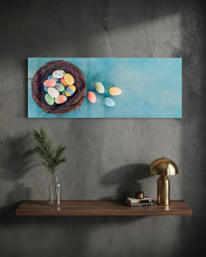 Easter eggs in a nest glass wall art on a charcoal wall above a floating shelf with a brass lamp and greenery