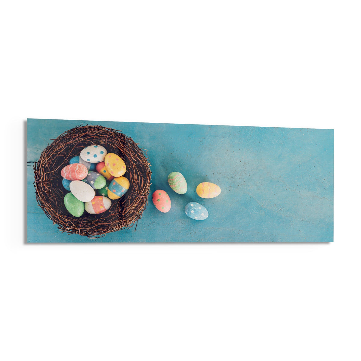 Easter eggs in a nest panoramic glass piece shown on a white background