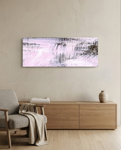 Blush pink brushstroke abstract glass wall art above a light wood sideboard beside a gray armchair with a throw