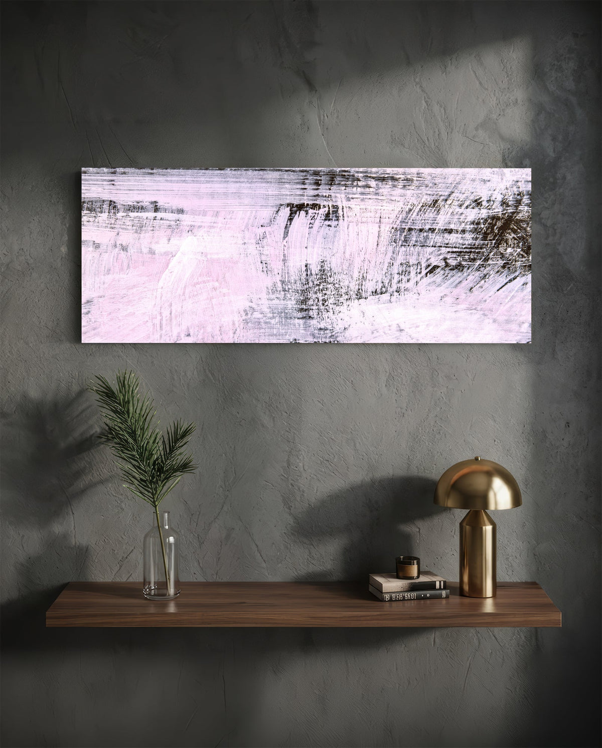 Blush pink brushstroke abstract glass wall art on a charcoal wall above a floating shelf with a brass lamp and greenery