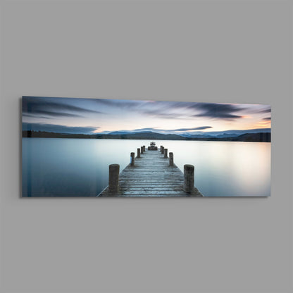 Blue hour lake jetty panoramic glass print angled on a gray background