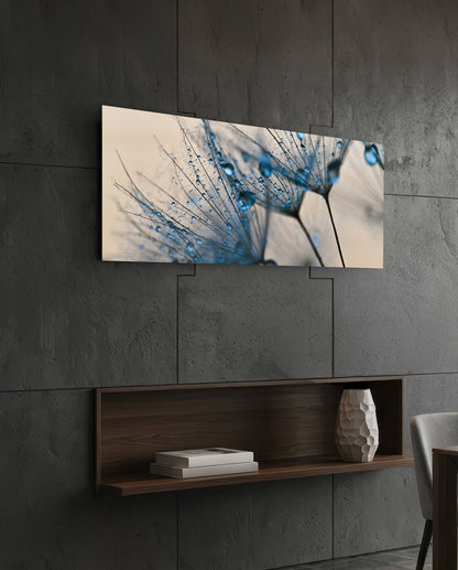Dandelion glass wall art on a dark tiled wall above an open walnut shelf with books and a vase