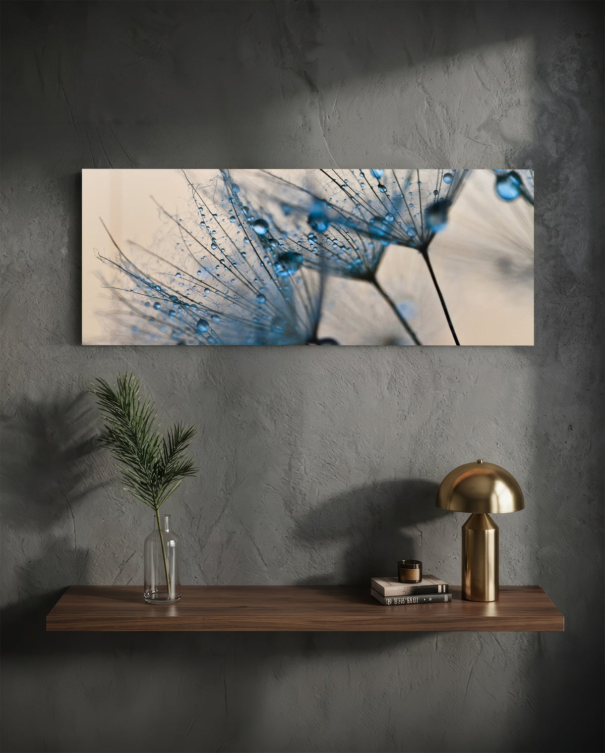 Dandelion seeds glass wall art on a dark plaster wall above a floating shelf with a brass lamp