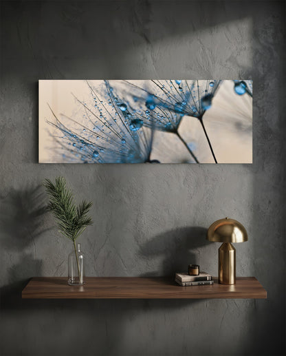 Dandelion seeds glass wall art on a dark plaster wall above a floating shelf with a brass lamp