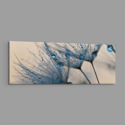 Blue dandelion seeds with water drops glass wall art on a plain gray background