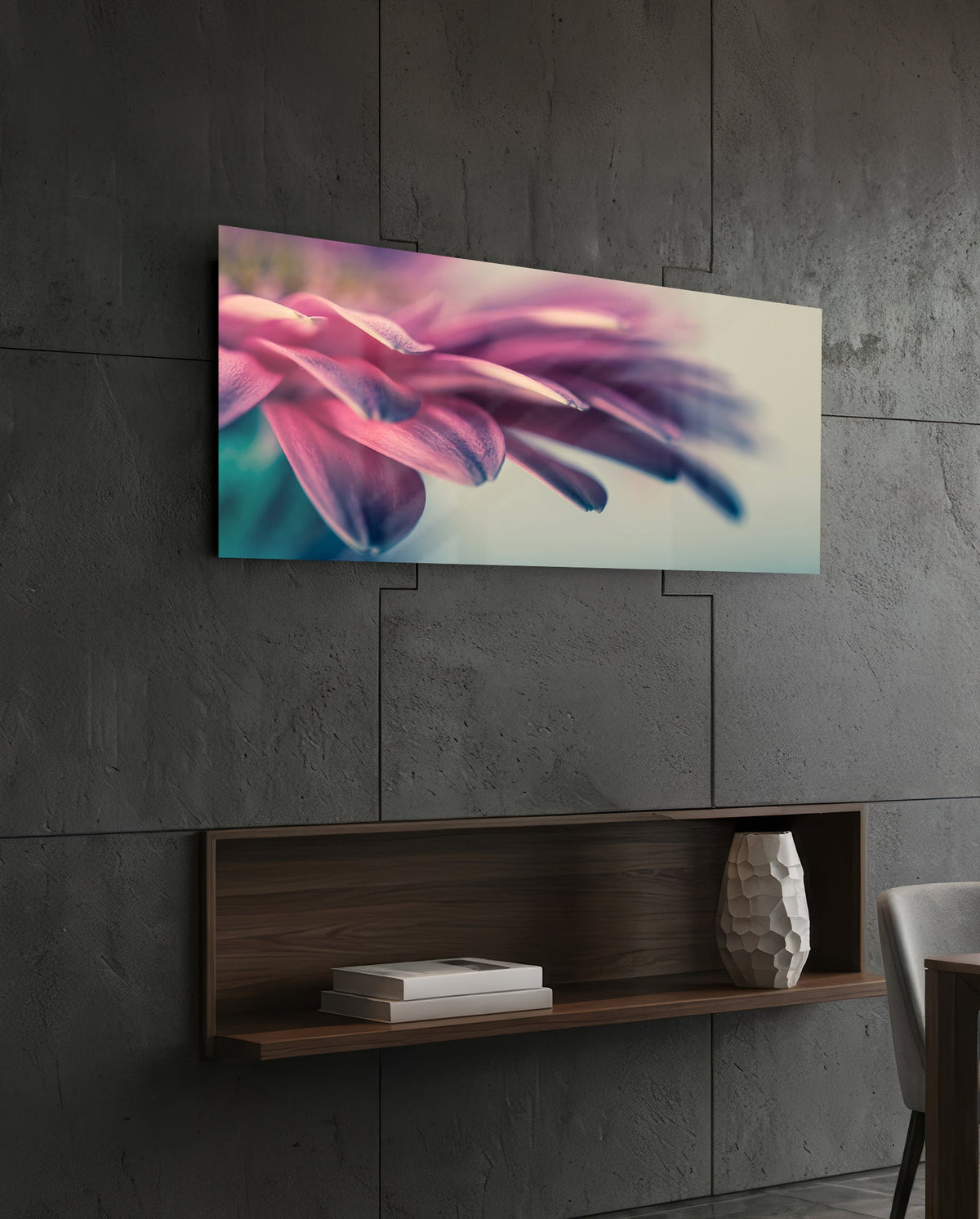 Pink flower petal macro glass wall art on a dark tiled wall above a recessed walnut shelf with a vase