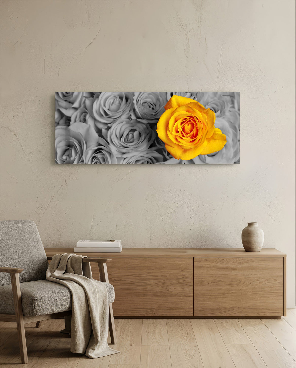 Yellow rose on gray roses glass wall art above an oak sideboard beside a wooden armchair with a throw