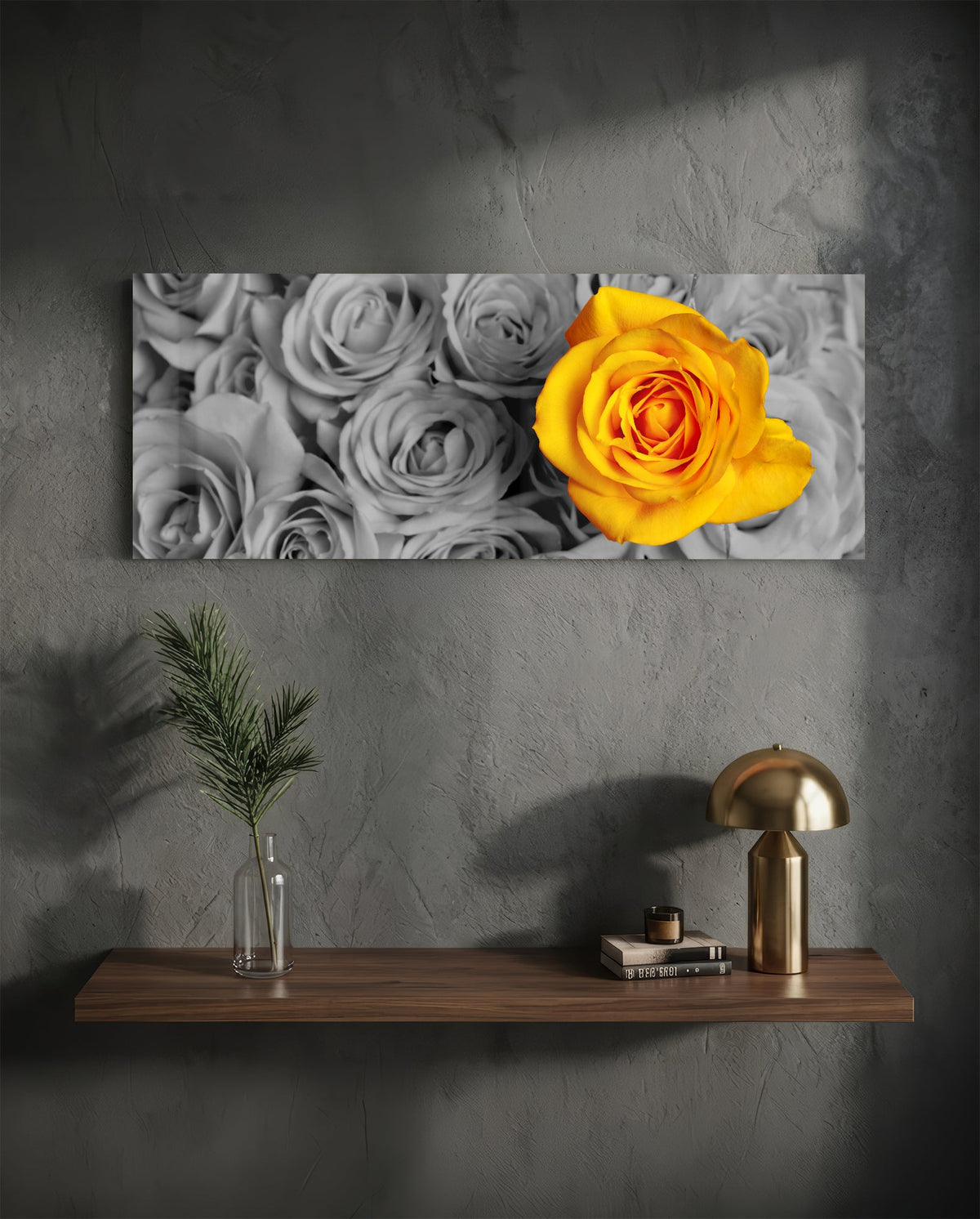 Yellow rose on gray roses glass wall art above a floating shelf with a brass lamp and a plant in a vase