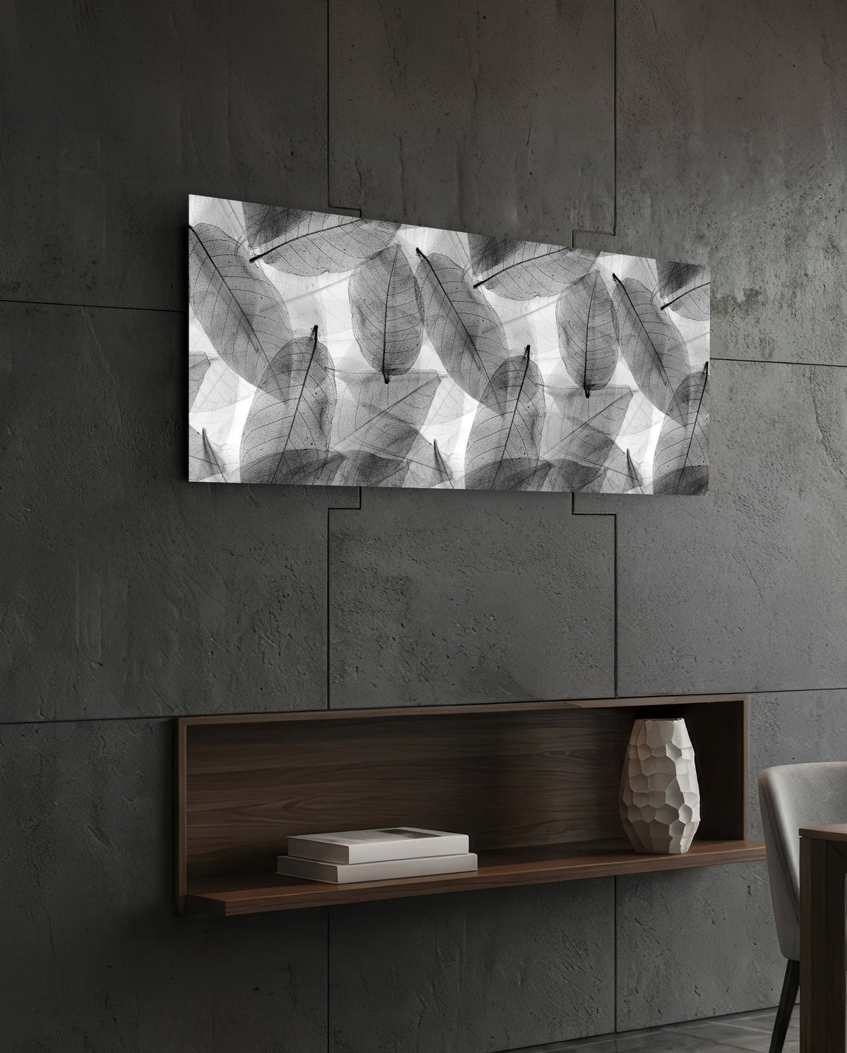 Black and white skeleton leaves glass wall art on a dark slate wall above a walnut floating shelf