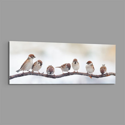 Seven sparrows on a bare branch glass wall art on a plain gray background