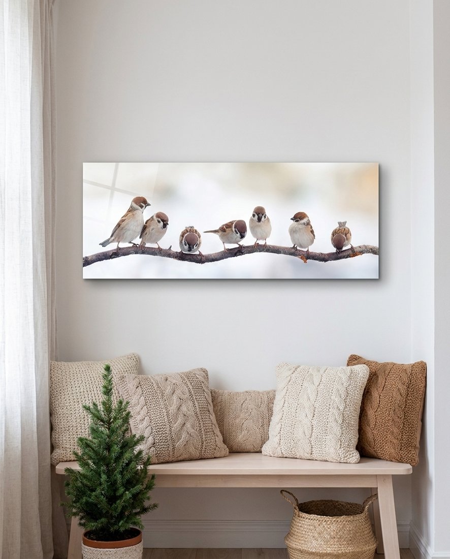 Seven sparrows panoramic glass wall art above a wood bench with knit pillows, a small pine tree and a basket