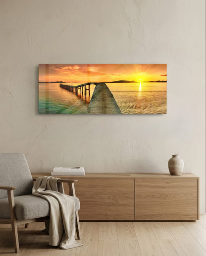 Golden sunset curved pier glass wall art above a light oak sideboard beside a cream armchair