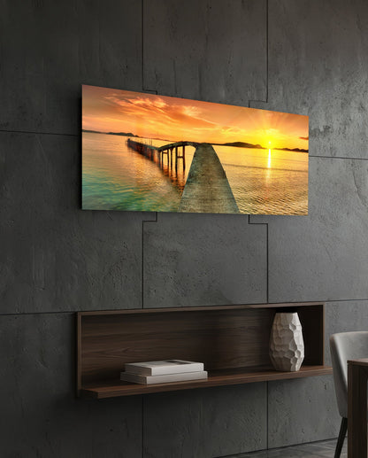 Golden sunset curved pier glass wall art above a dark wood wall shelf on a charcoal paneled wall