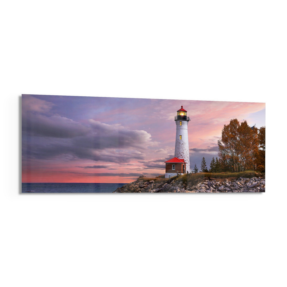 Lighthouse at dusk panoramic glass print angled on a white background