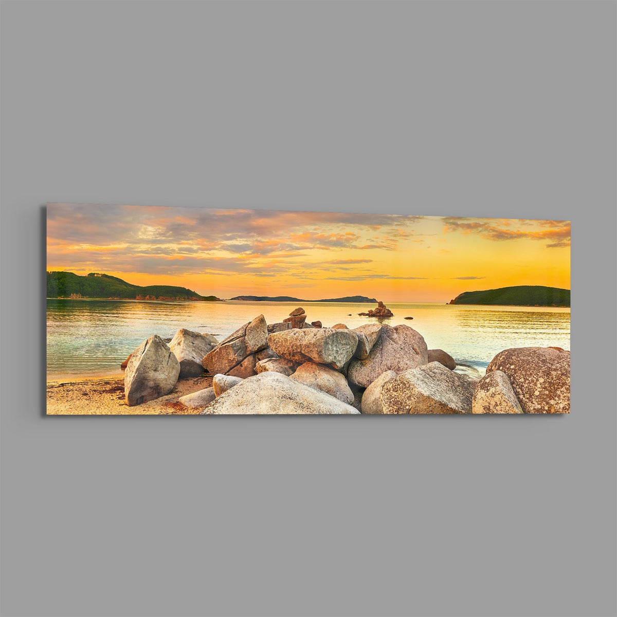 Golden sunset boulder bay panoramic glass print angled on a gray background