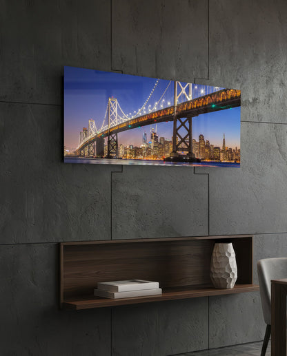 San Francisco Bay Bridge panoramic glass wall art on a dark wall above a recessed wooden shelf