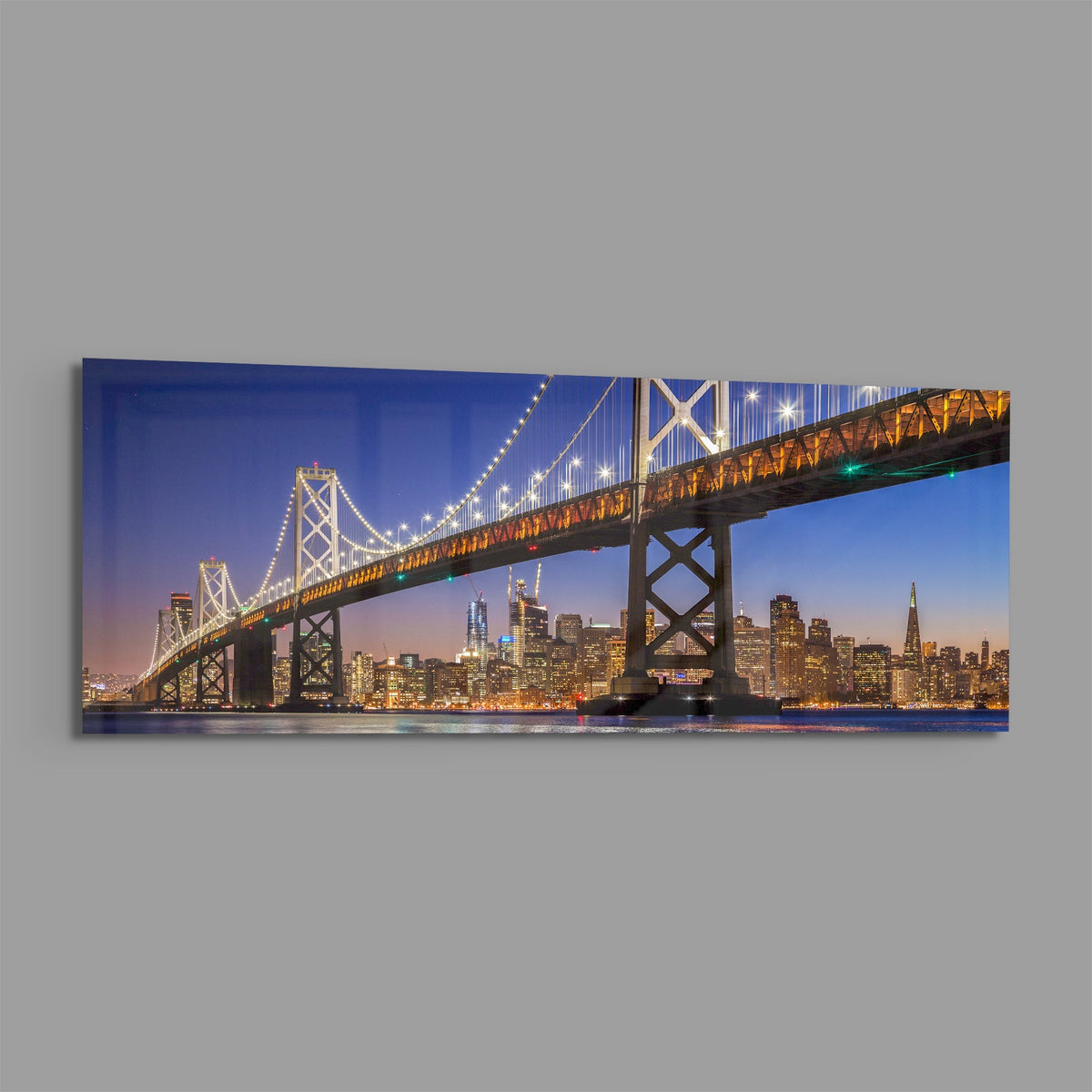 San Francisco Bay Bridge panoramic glass wall art shown at an angle on a gray background