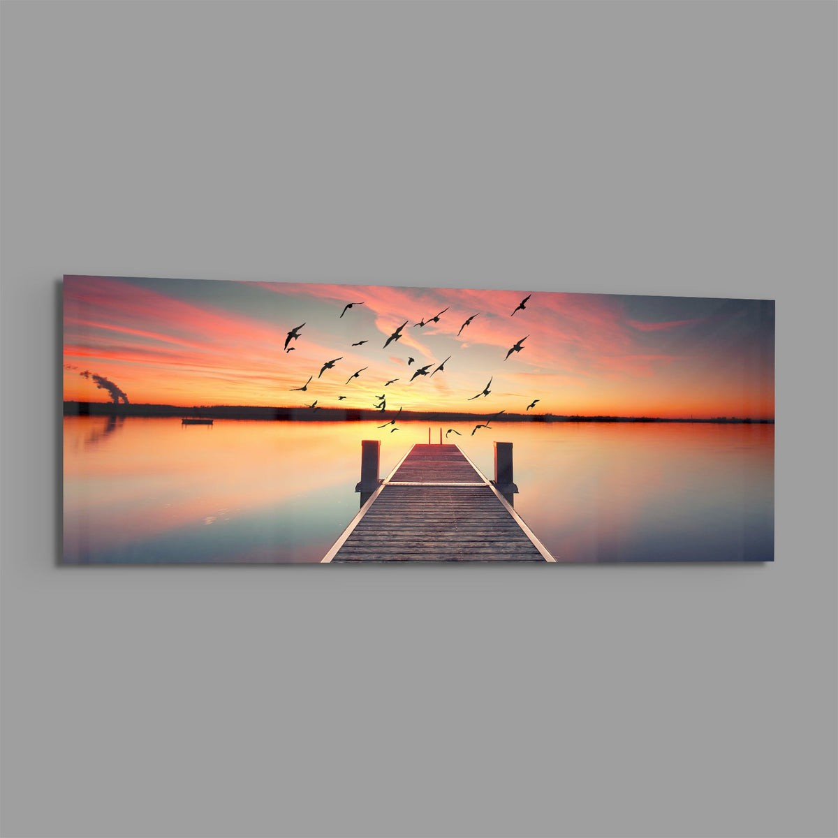 Sunset pier panoramic glass wall art on a plain gray background