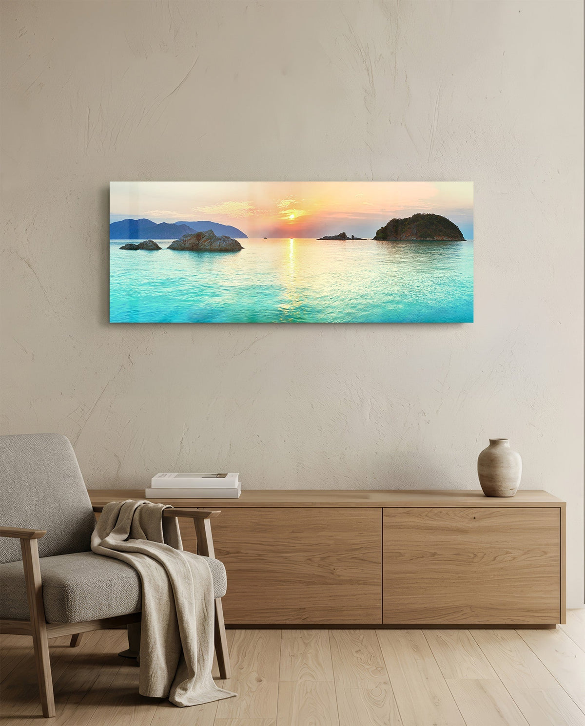 Turquoise bay islets at sunset glass wall art above a light oak sideboard beside a cream armchair