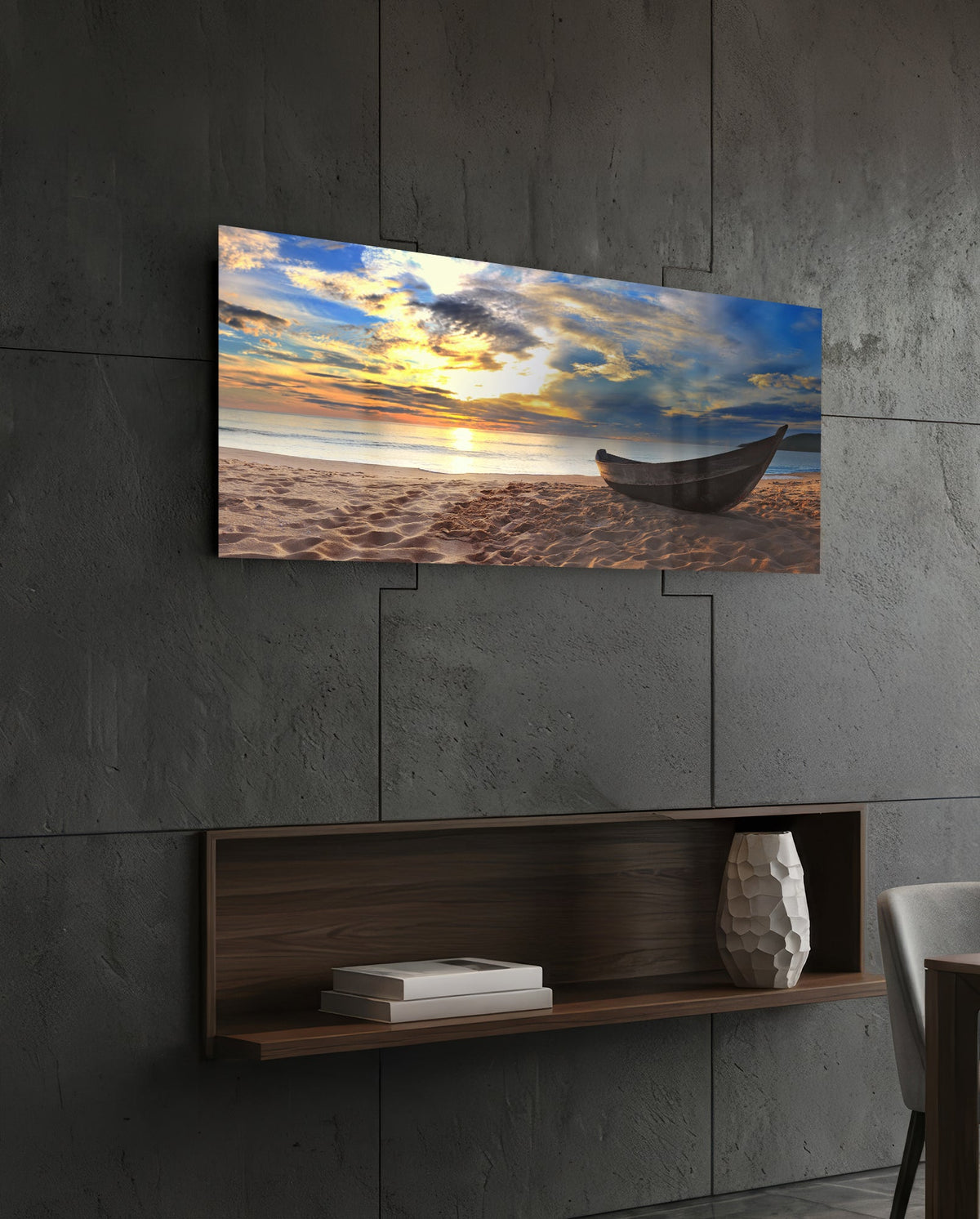 Wooden boat on a sandy beach at sunset glass wall art above a dark wood wall shelf on a charcoal paneled wall
