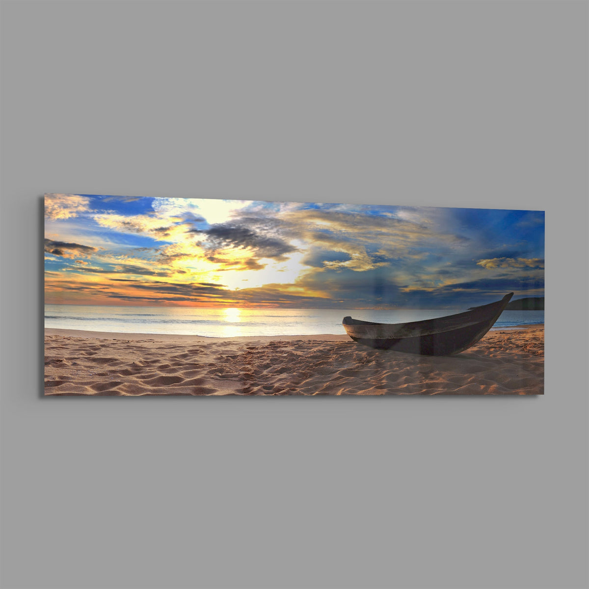 Wooden boat on a sandy beach at sunset panoramic glass print angled on a gray background
