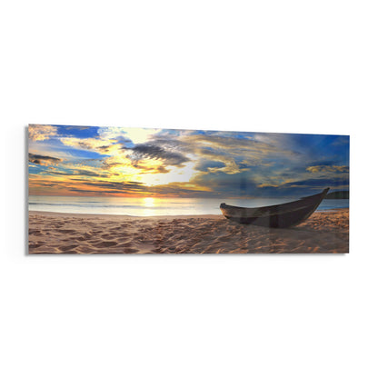 Wooden boat on a sandy beach at sunset panoramic glass print angled on a white background