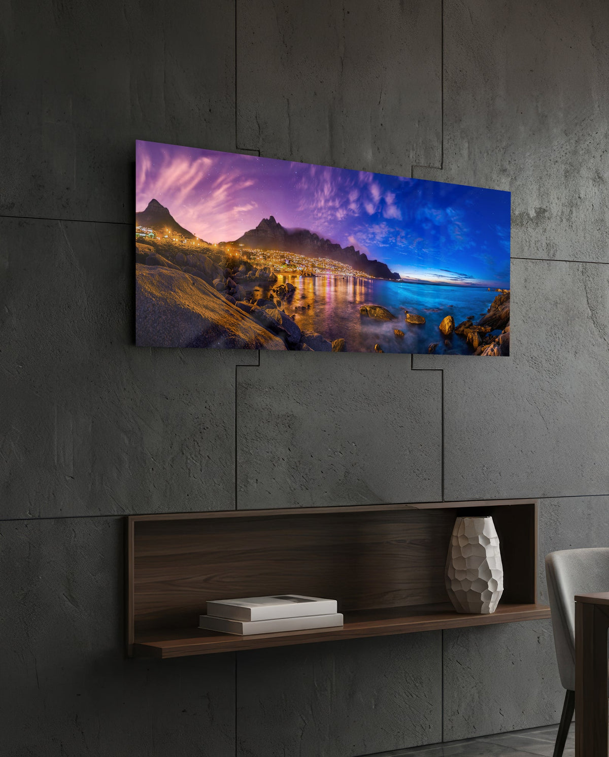 Coastal town at dusk panoramic glass wall art on a dark wall above a recessed wooden shelf