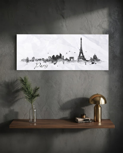 Paris ink skyline panoramic glass wall art on a dark wall above a shelf with a gold lamp