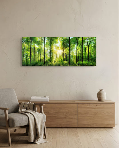 Green beech forest sunburst panoramic glass wall art above a light wood sideboard beside a gray armchair