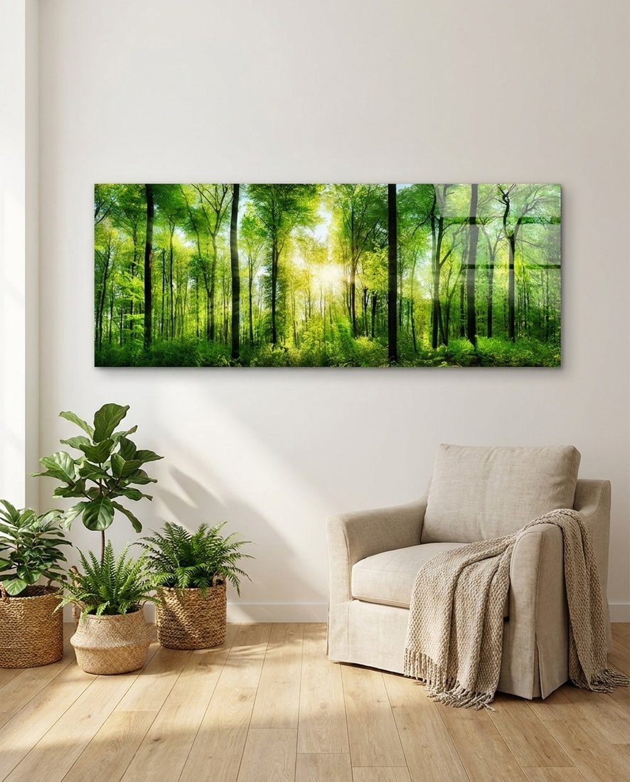 Green beech forest panoramic glass wall art above a cream armchair beside potted plants