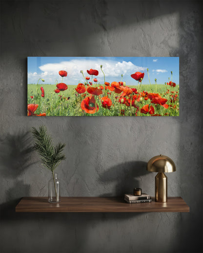 Red poppy field glass wall art above a floating shelf with a brass lamp and a plant in a vase