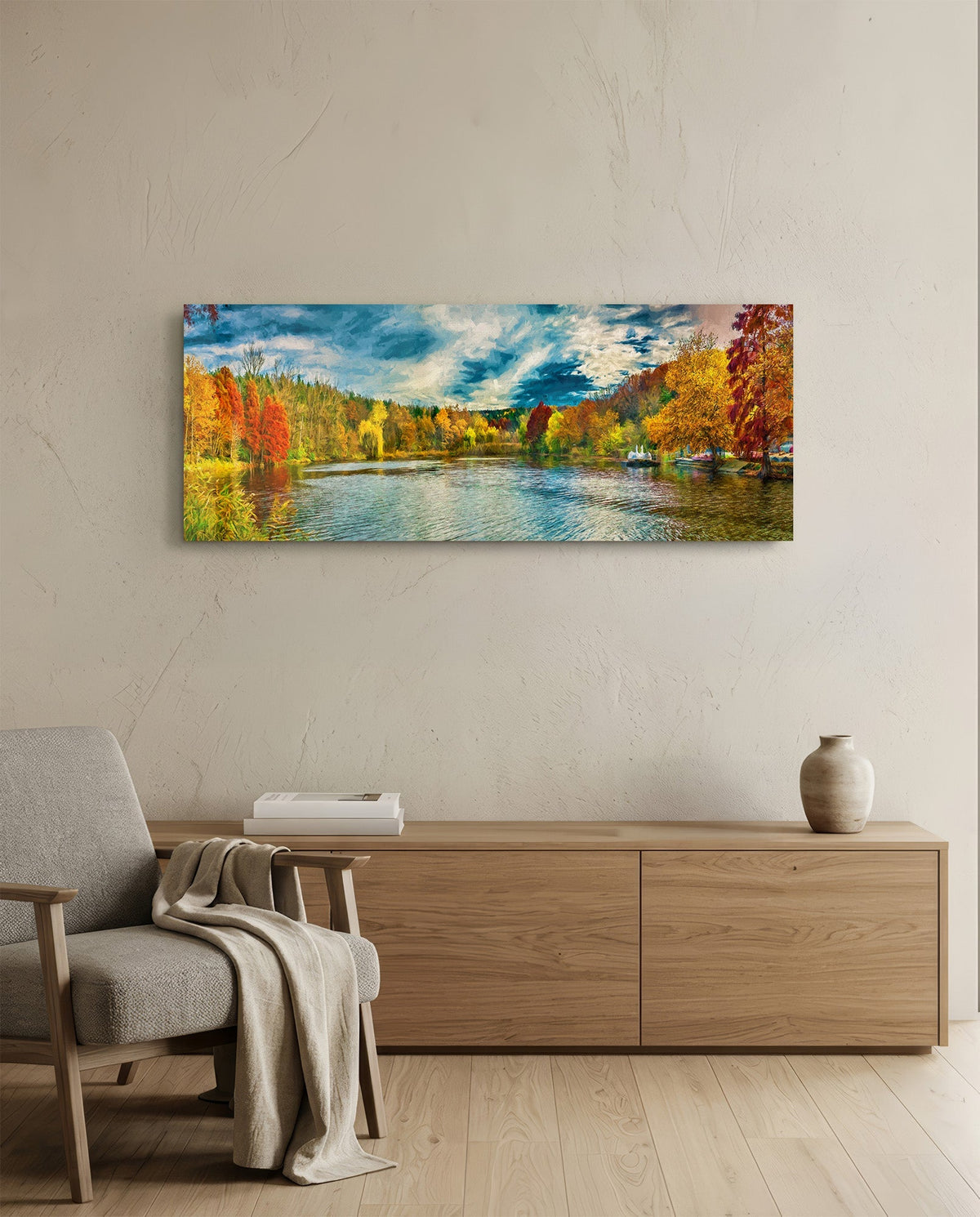 Autumn lake panoramic glass wall art above a wooden sideboard beside an armchair with a throw