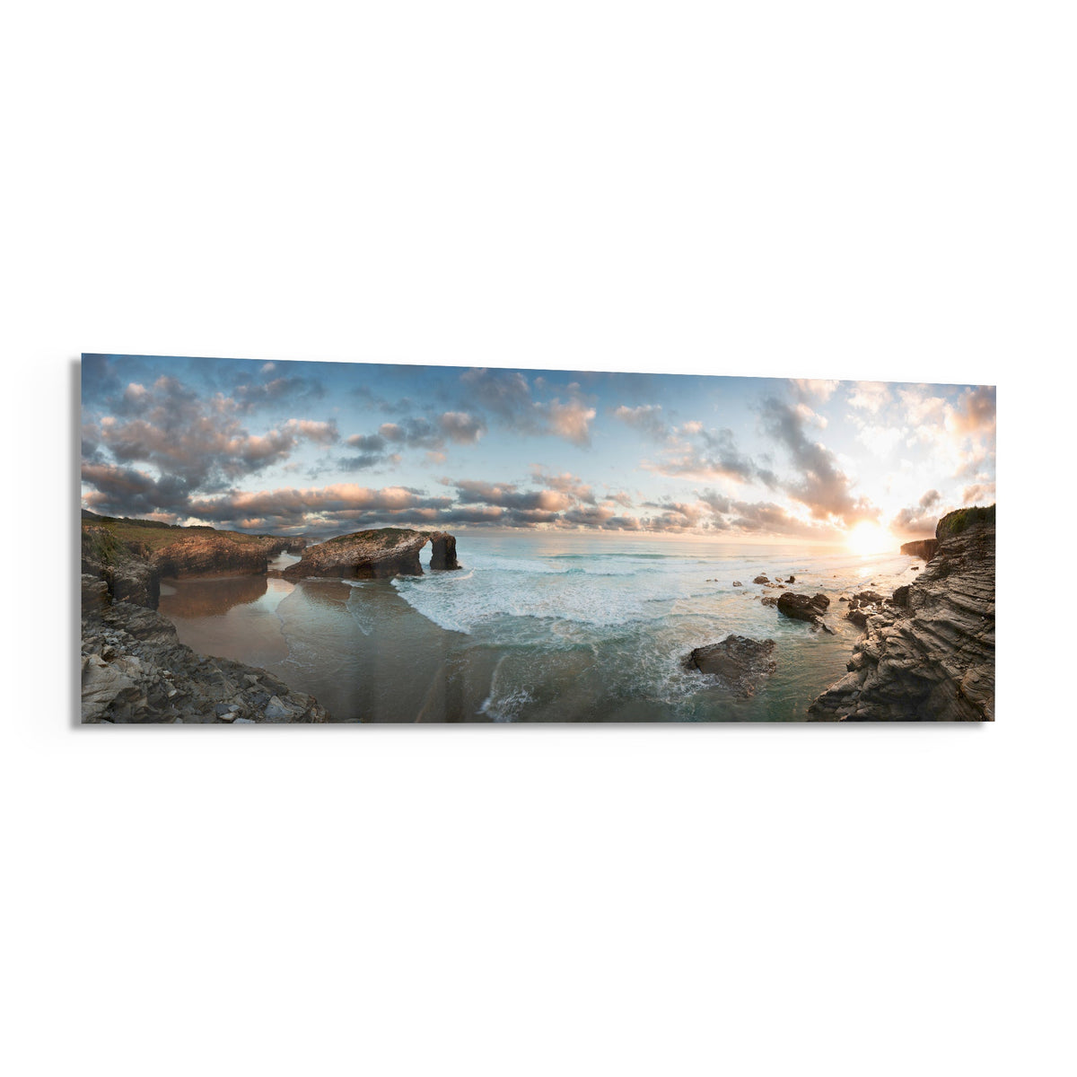 Rock arch coastline at sunset panoramic glass print angled on a white background