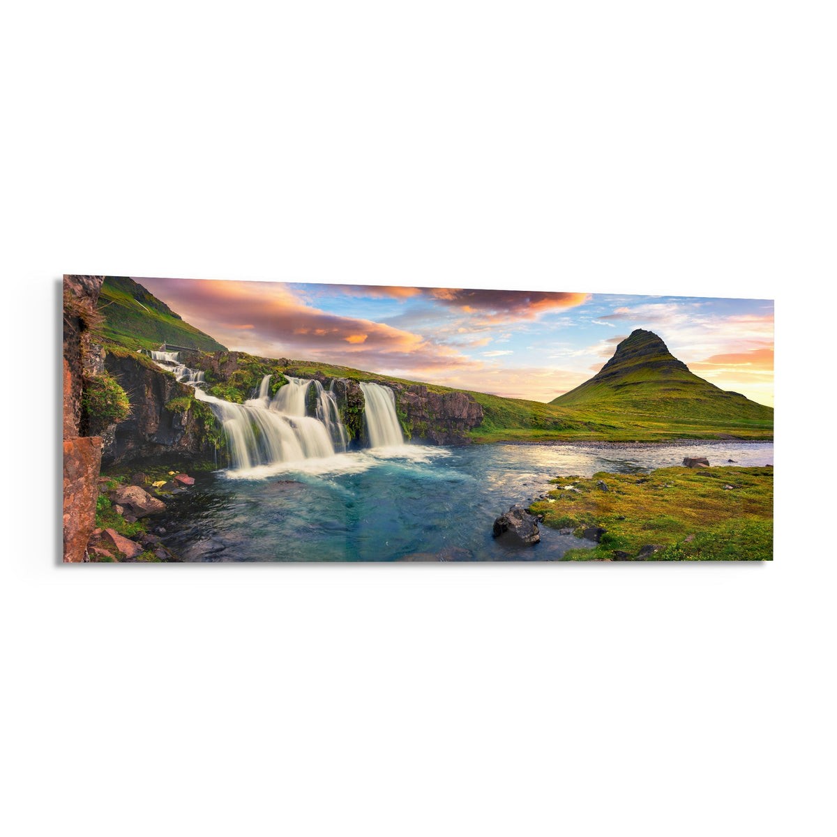 Waterfall and cone mountain panoramic glass wall art angled on a white background