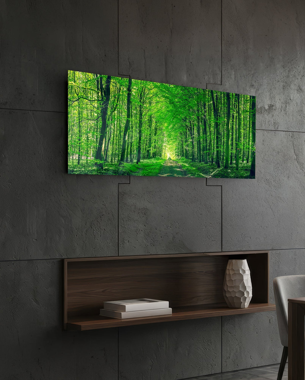 Green forest path glass wall art on a dark slate wall above a walnut floating shelf