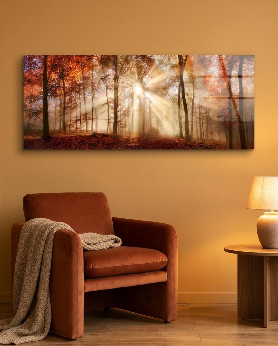 Autumn forest sun rays panoramic glass wall art above a rust velvet armchair and a side table lamp