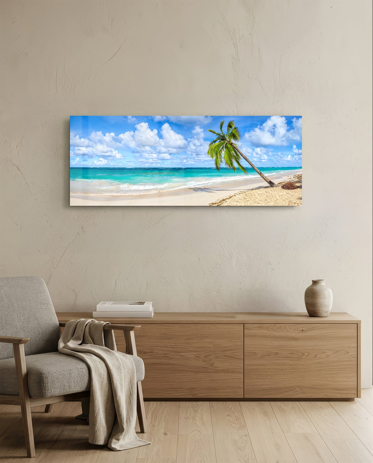 Tropical palm tree beach glass wall art above a light oak sideboard beside a cream armchair