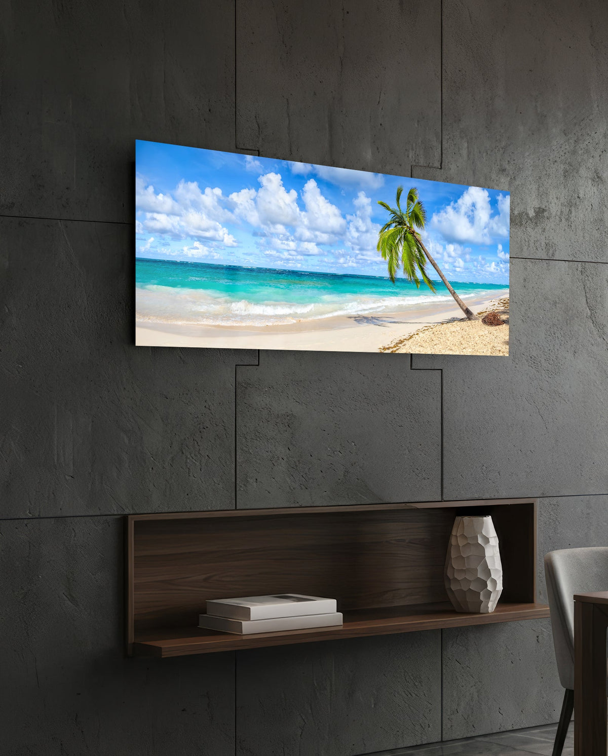Tropical palm tree beach glass wall art above a dark wood wall shelf on a charcoal paneled wall