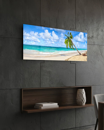 Tropical palm tree beach glass wall art above a dark wood wall shelf on a charcoal paneled wall