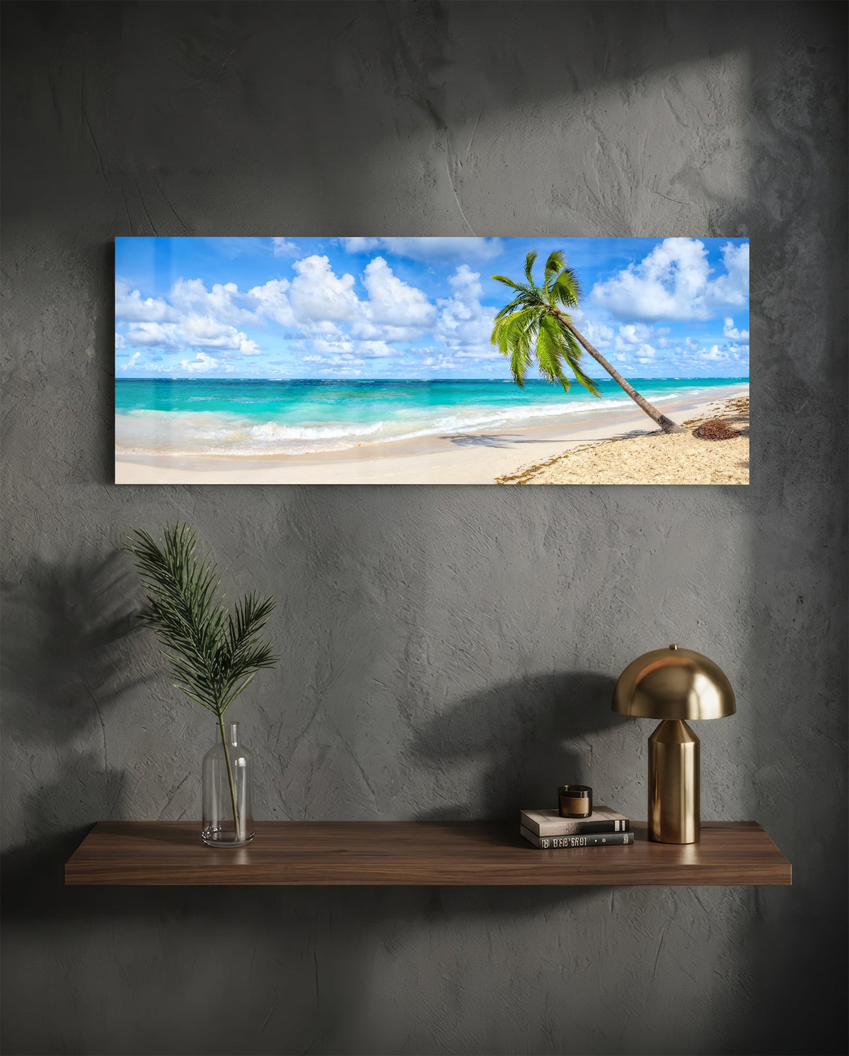 Tropical palm tree beach glass wall art above a floating walnut shelf with a brass lamp