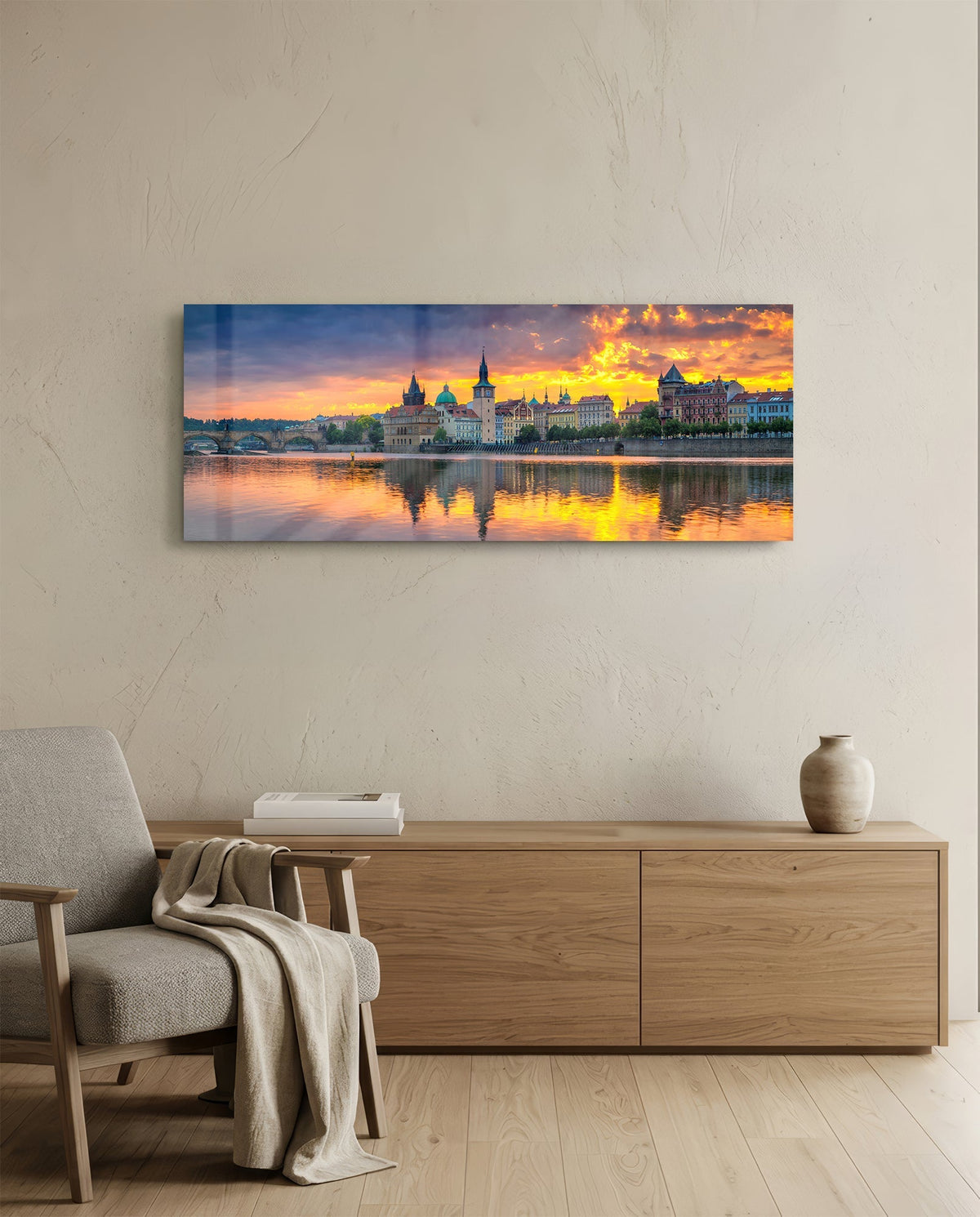 Prague riverside sunset panoramic glass wall art above a light wood sideboard and beige armchair