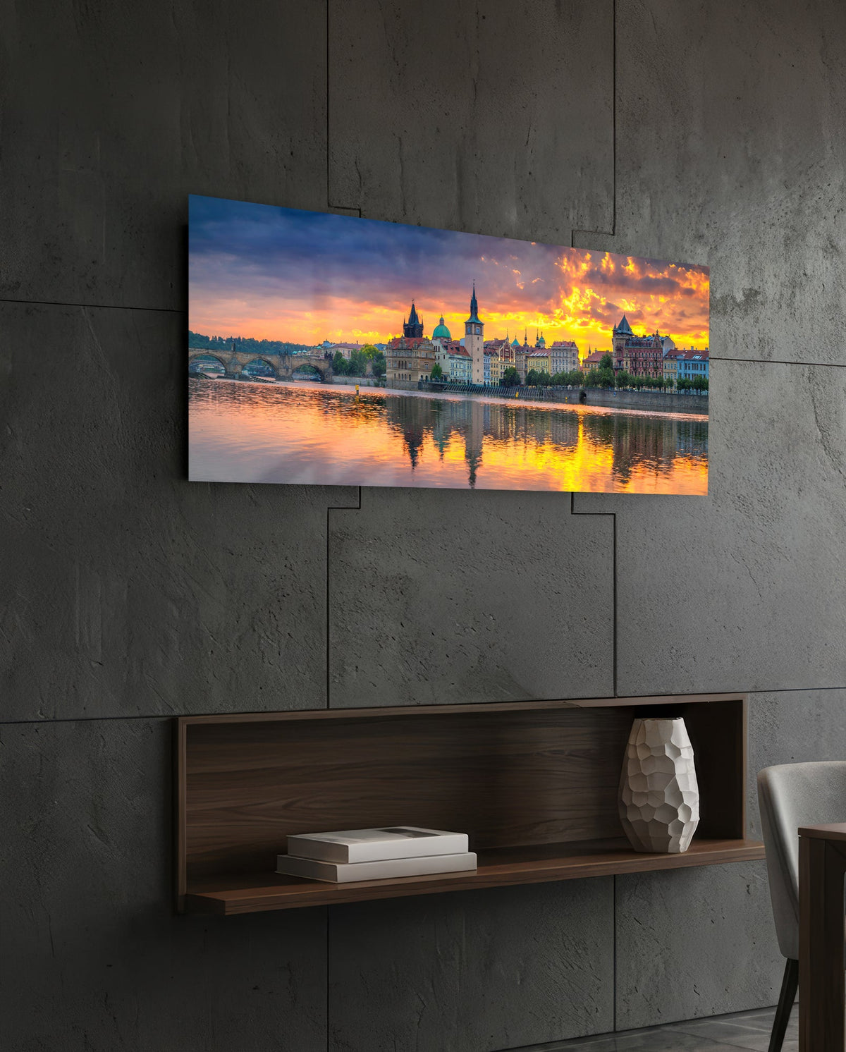 Prague riverside sunset panoramic glass wall art on a dark wall above a recessed wooden shelf