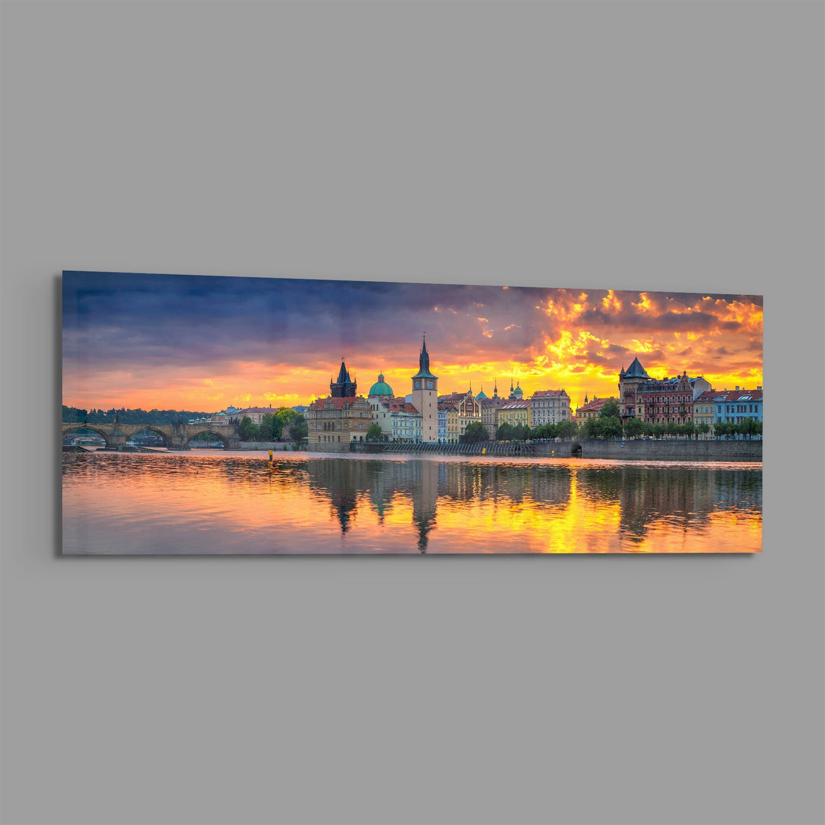 Prague riverside sunset panoramic glass wall art shown at an angle on a gray background