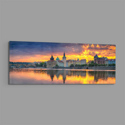 Prague riverside sunset panoramic glass wall art shown at an angle on a gray background