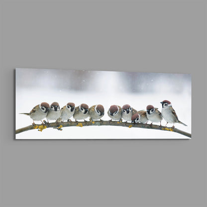 Snowy sparrow flock on a lichen branch glass wall art on a plain gray background